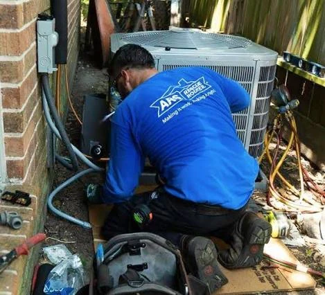 Technician working on an outdoor HVAC unit in a narrow service area